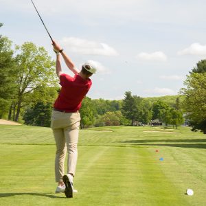 golfer teeing off at The Reliant Foundation Drive For a Difference Golf Tournament and Live Auction